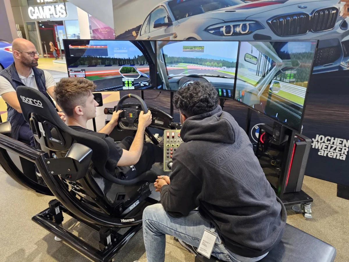 Marian coaching drivers at a sim racing event.