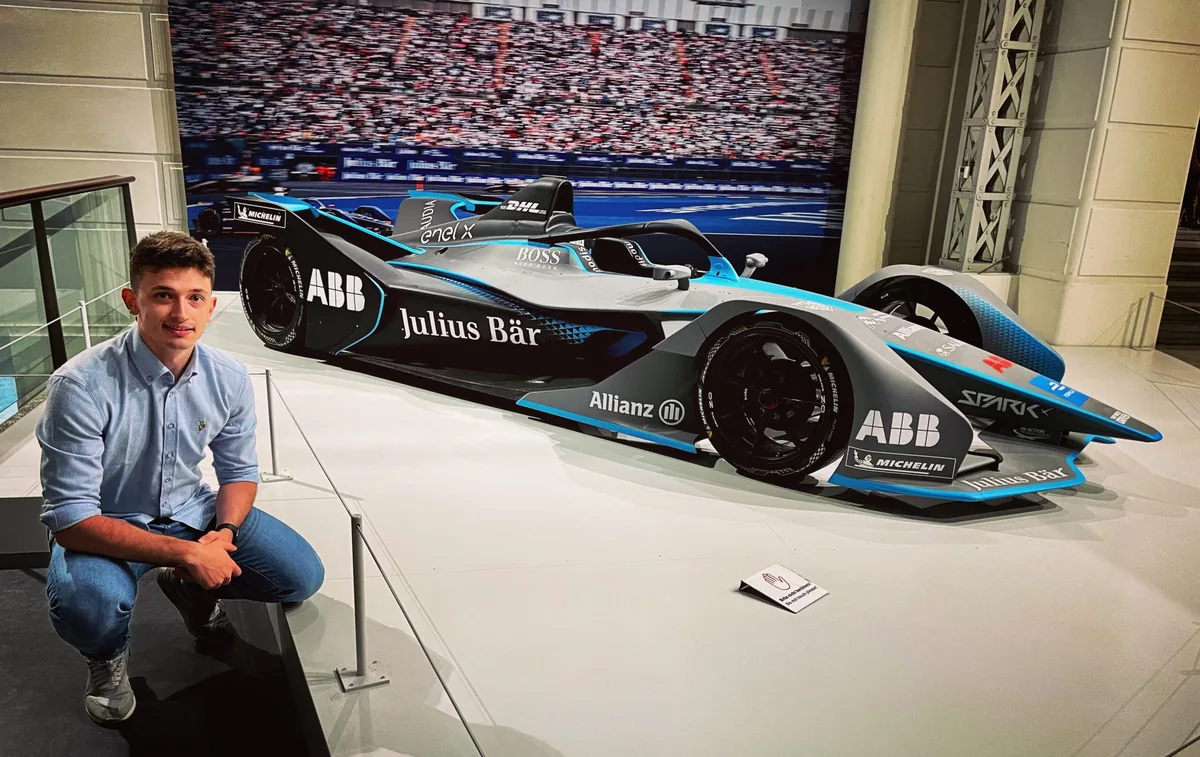 Marian beside a Formula E car.