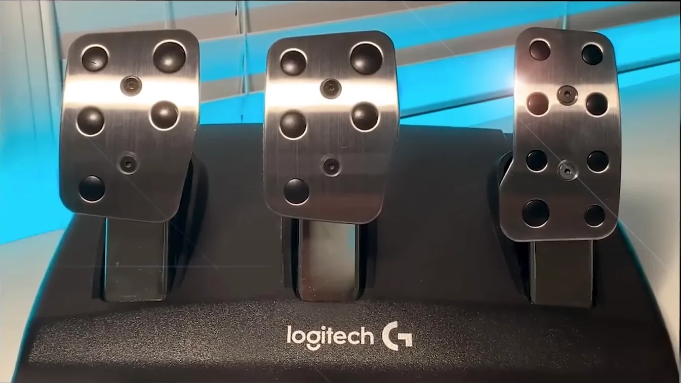 Logitech G three-pedal set with steel pedal faces on a black base, the entry-level potentiometer pedals the brake pedal settings sim racing guide says to run as stiff as possible.