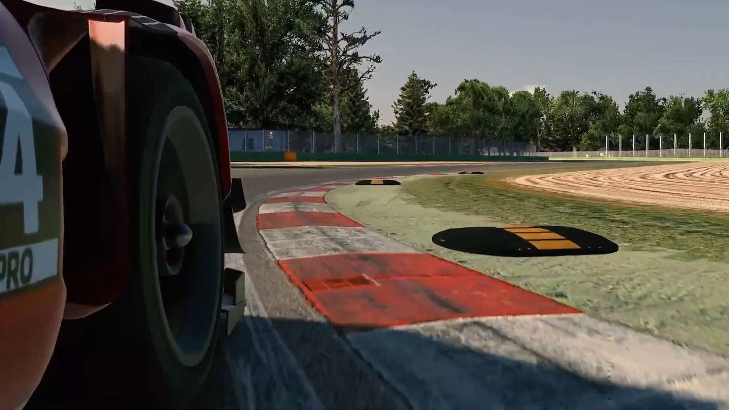 Low exterior shot of a GT3 car running along a wide red-and-white kerb with sausage kerbs behind in iRacing, the kerb physics that shape force feedback settings for sim racing.
