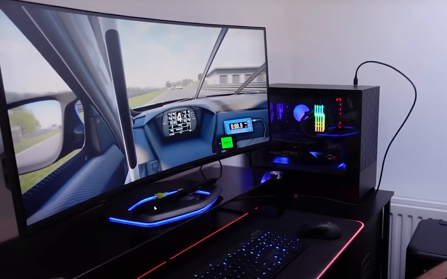 A single curved monitor showing an in-game cockpit with a tracker bar sitting beneath the screen on a desk rig, the hardware eye-tracking option among cheap sim racing mods.