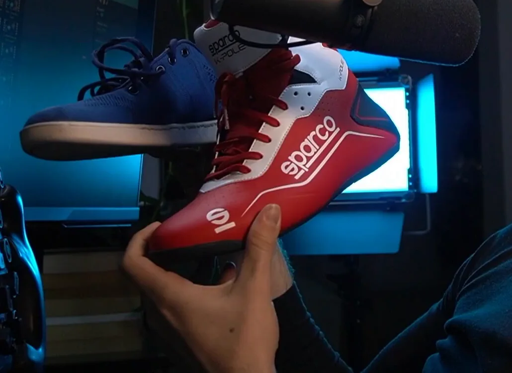A blue lightweight flat shoe held next to a red and white Sparco racing boot, the two pairs compared in this cheap sim racing upgrades list.