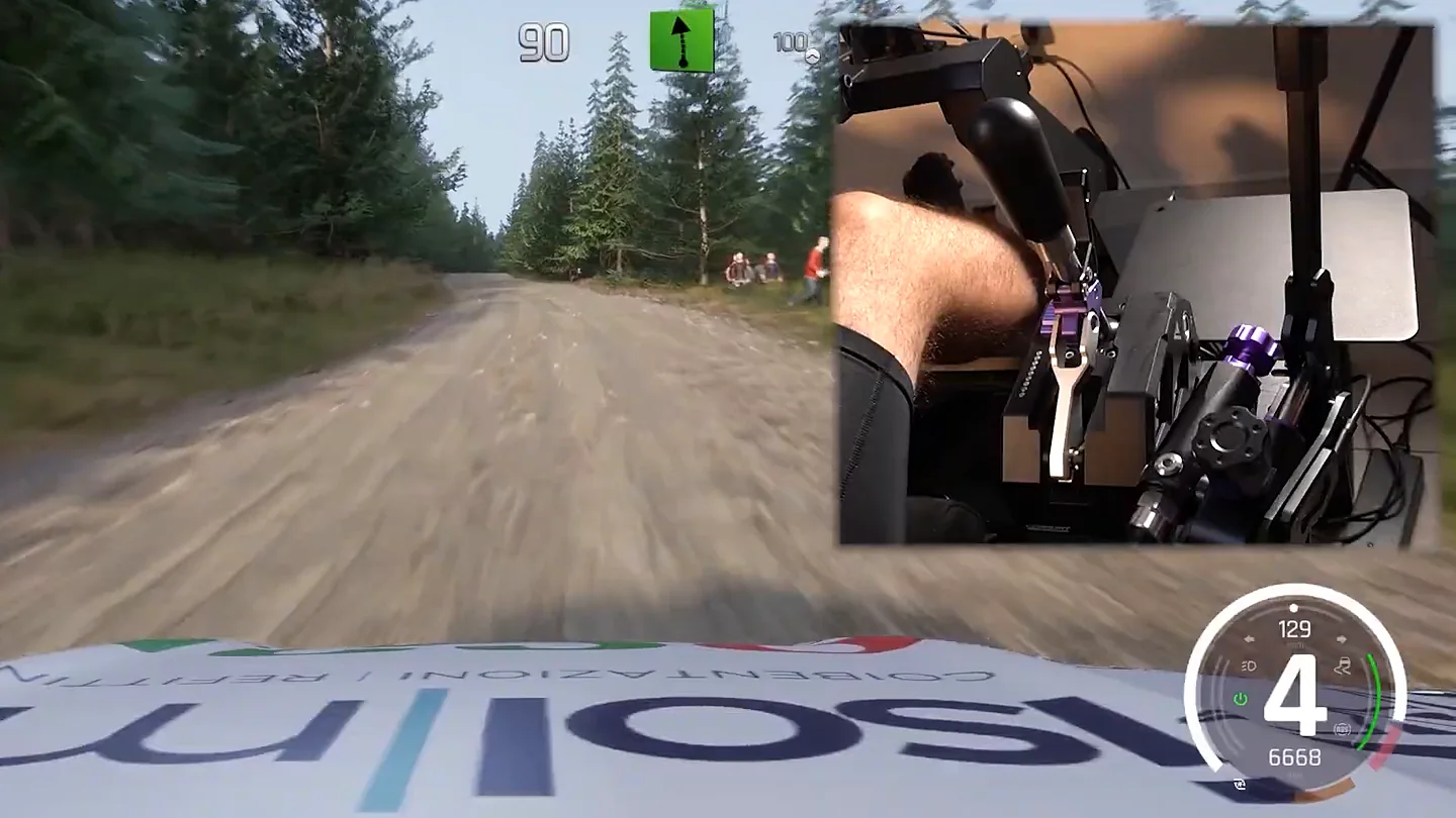 Conspit CHS in H-pattern mode on a gravel rally stage, with an inset camera of the shifter lever and fourth gear on the in-game readout