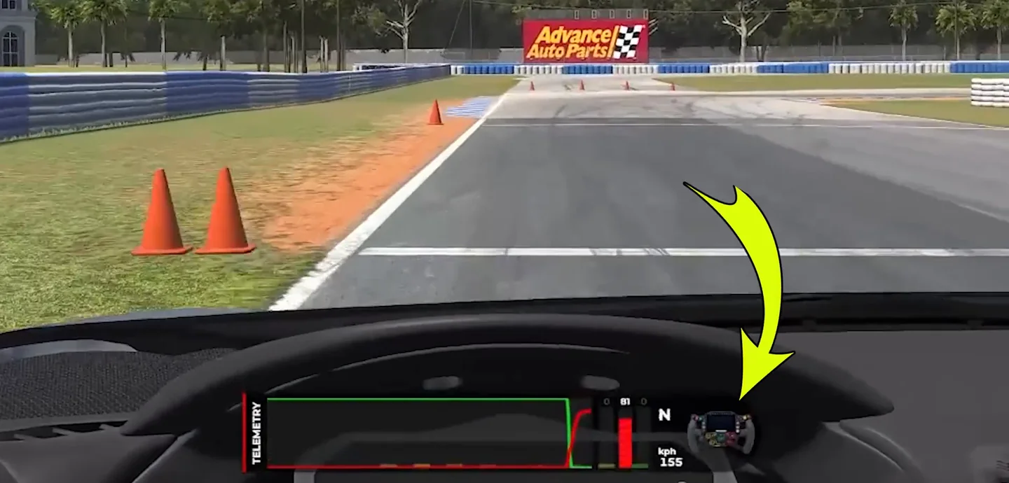 Cockpit view braking hard for a cone-marked corner with a yellow arrow pointing at the steering wheel held almost straight, the threshold-phase habit needed to fix trail braking.
