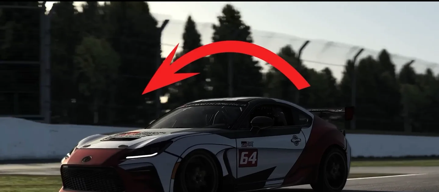 A Toyota GR86 entering a corner with a red arrow drawn over it showing weight moving forward onto the nose, the load transfer that lets you fix trail braking rotation.