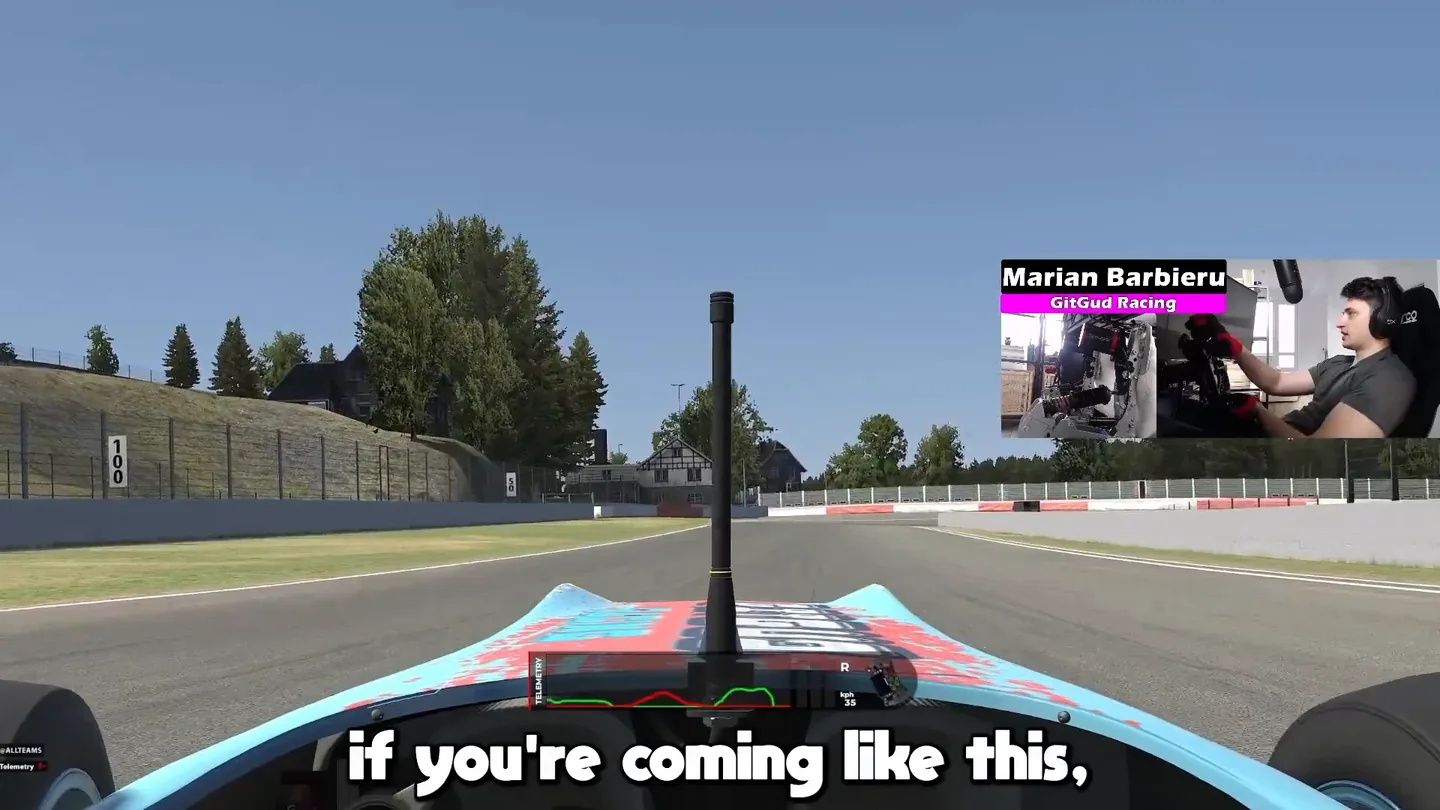 Onboard view approaching a corner with a distance board and painted lines visible beside the track