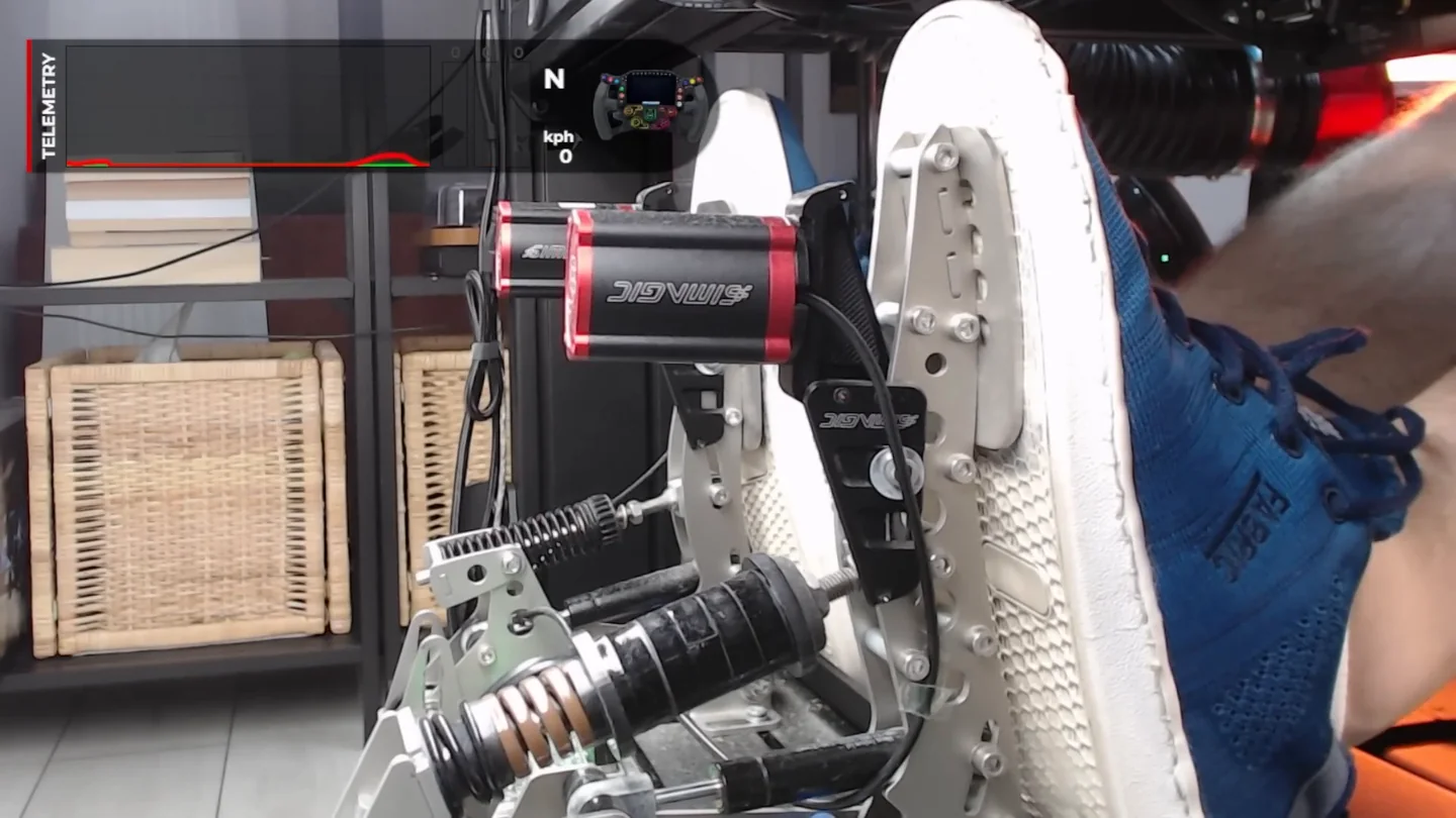 Close-up of a foot on a sim racing brake pedal pressing with the ball of the foot while the heel stays planted, with a telemetry overlay showing a small brake input, the pedal feel that trail braking in sim racing depends on.