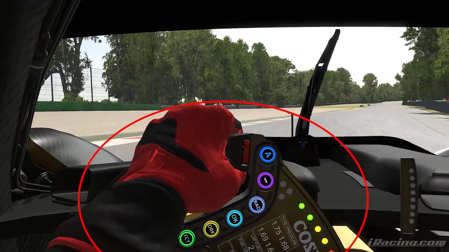 Red-gloved hands holding a prototype's steering wheel turned far into a corner, circled in red by the coach in the iRacing tire management video.