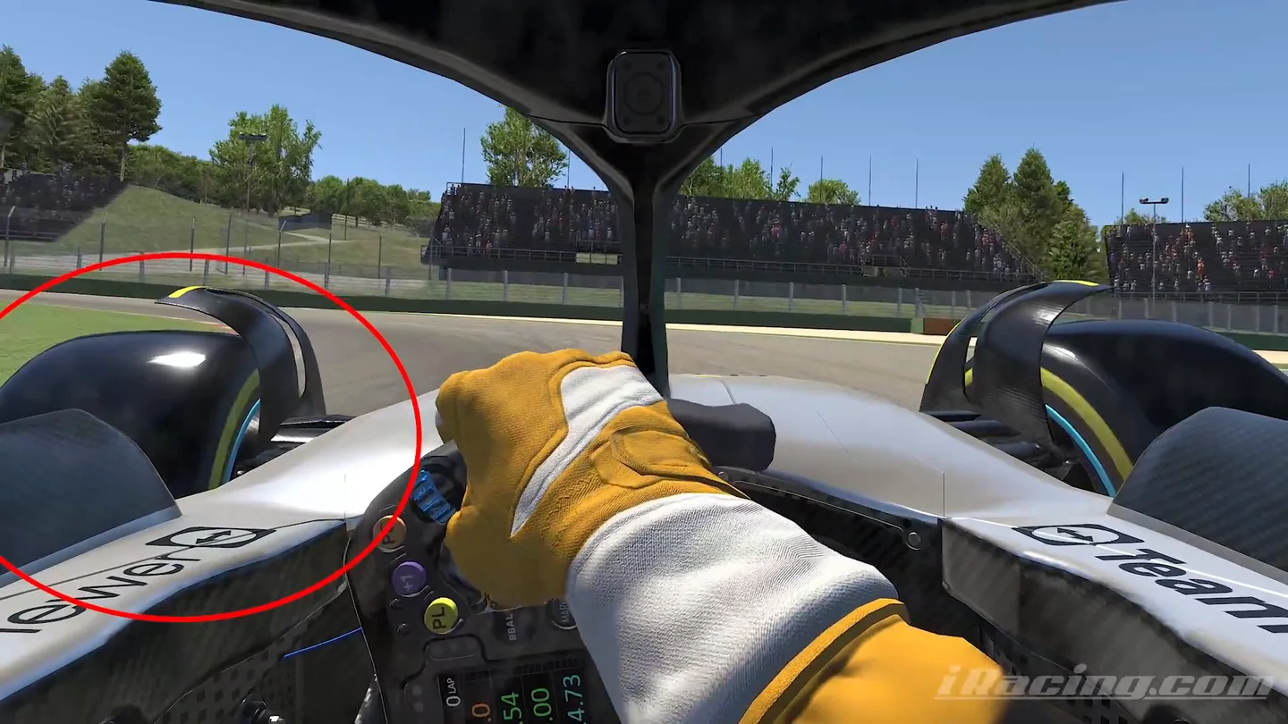 Formula 1 onboard view with the coach's red circle around the front-left wheel, marking where the small lockup happens in the iRacing tire management video.