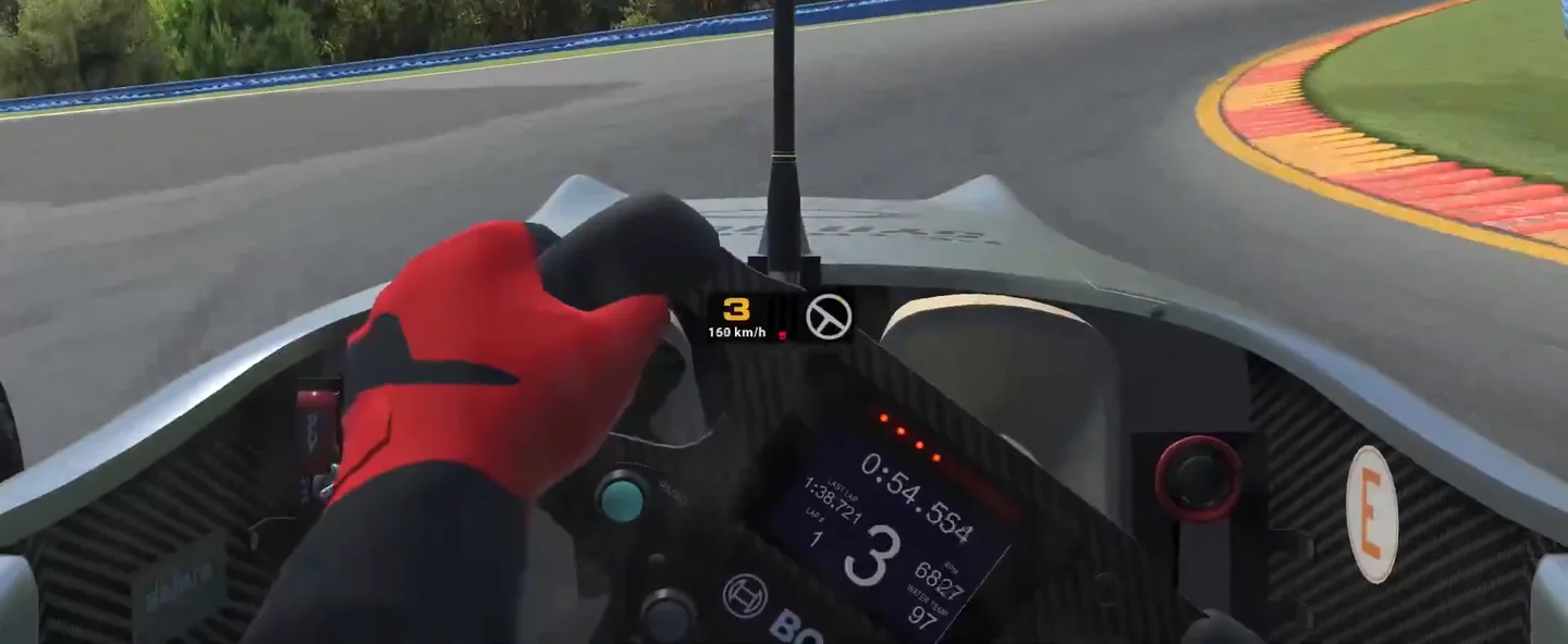 Cockpit view mid-corner with both gloved hands holding steering lock on the wheel, where the sim racing grip limit is read from how the wheel's weight changes.