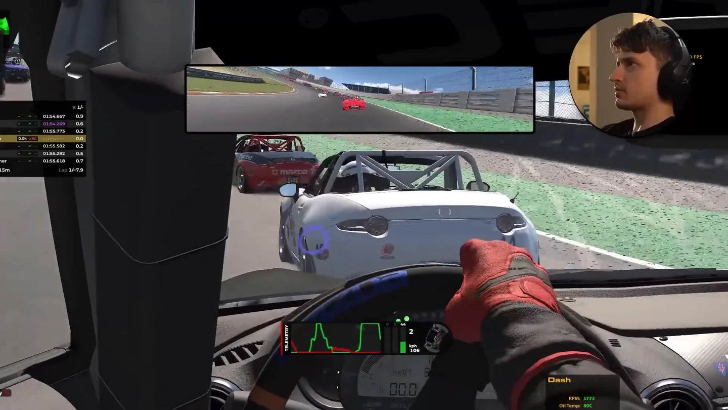 Mazda MX-5 cockpit view in iRacing turned left toward a white car running alongside, the wheel-to-wheel situation where sim racing head tracking replaces a guess with information.
