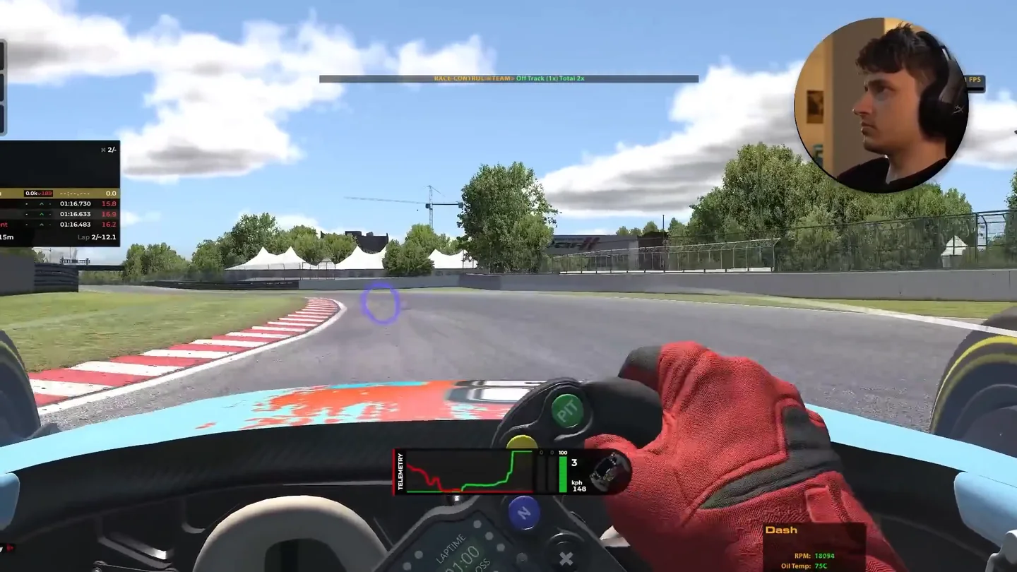 In-car view turned toward the kerb of a tight corner with a purple gaze marker on the road beyond the apex, the corner vision sim racing head tracking gives on a single screen.