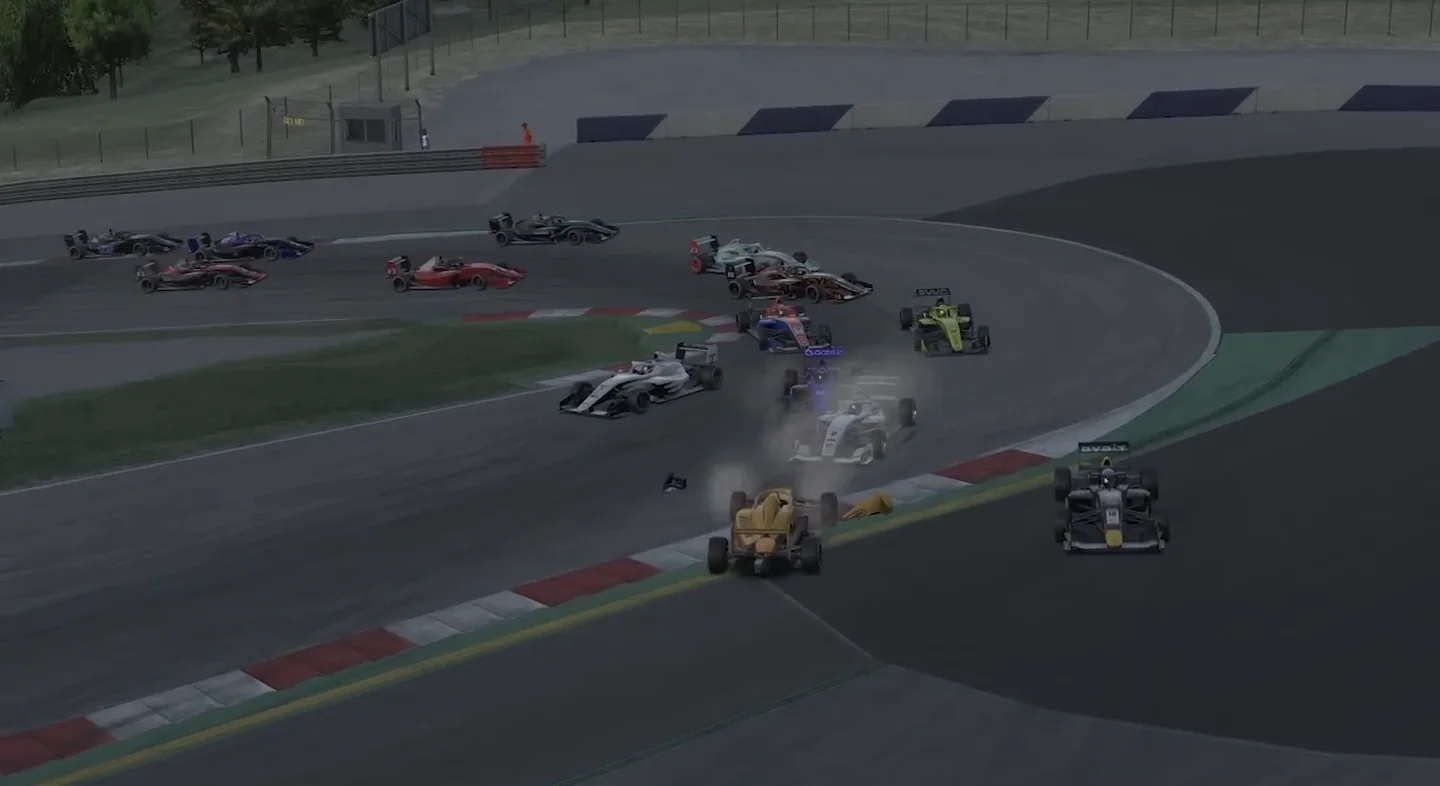 Open-wheel cars scattered across a corner exit with debris and tyre smoke after a multi-car pile-up, the moment that tests any sim racing mindset.