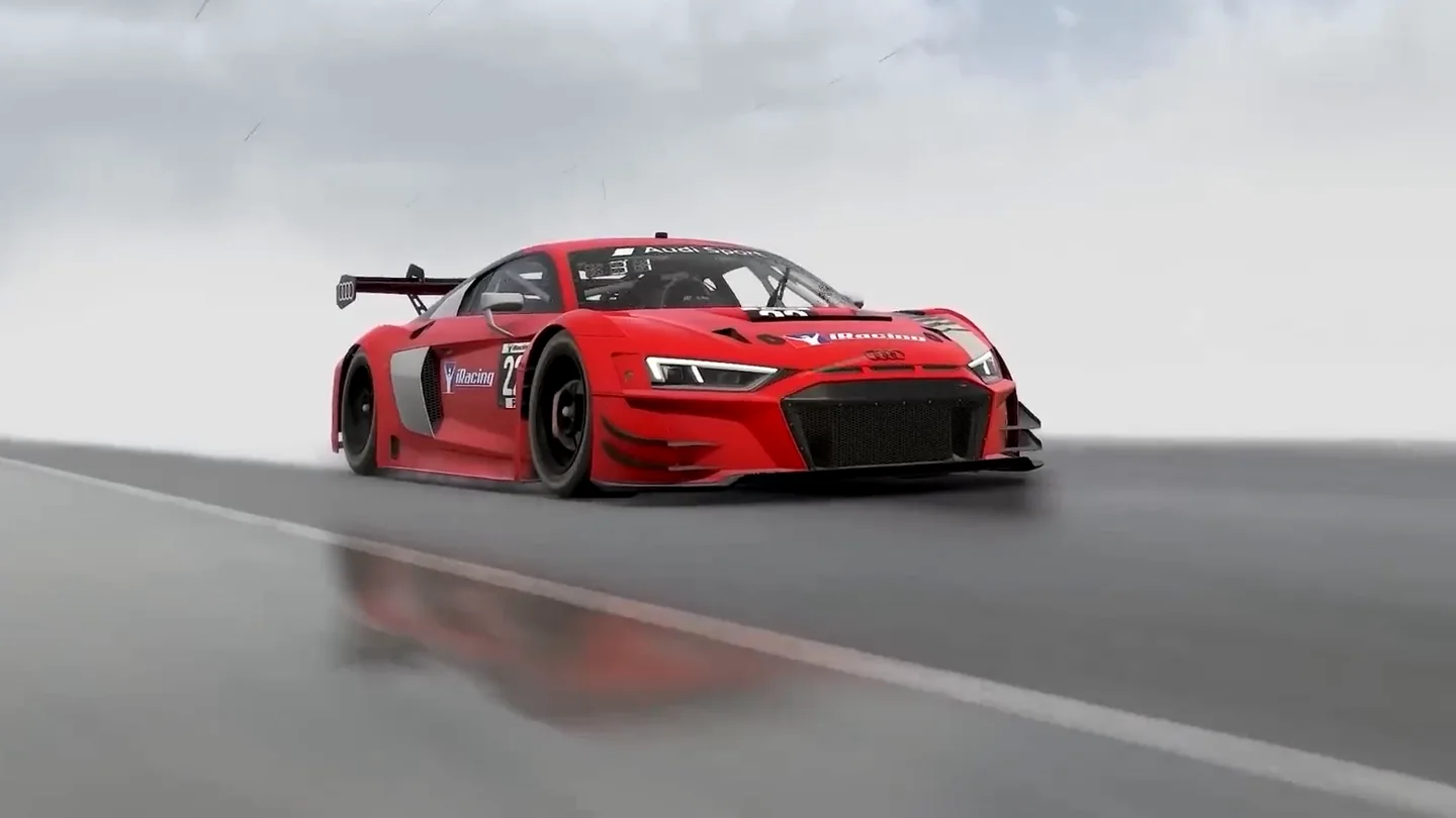 A red GT3 car runs alone on a soaking wet track, its reflection in the standing water, the grip these sim racing truths test.